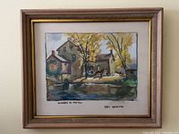 Front view of framed watercolor painting showing autumn mill scene