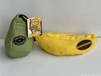 Green Pairs in Pear pouch next to yellow Bananagrams pouch to compare size and condition.