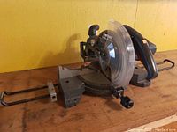 Side view of Craftsman miter saw showing extended handles and blade guard.