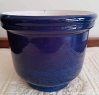 Side view of the royal blue ceramic flower pot showing smooth, glossy finish with no visible damage.