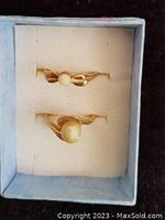 Two 10K gold pearl rings in cushioned jewelry box