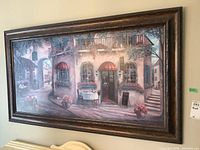 View of the entire framed street scene print hanging on wall showing detail and overall appearance.