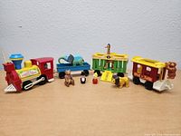 Full set arranged on flat surface showing locomotive, wagons, and figures