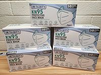 Five boxes of Dr. Talbot's KN95 disposable protective face masks stacked showing front of boxes with product name and quantity.