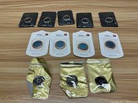 Lot of assorted new cell phone ring accessories displayed on wooden surface for sale