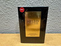 Front view of the new cologne box showing the gold metallic label and red 'NEW' sticker.
