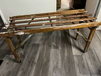 Front angle of the wooden washing cart showing slatted top and caster wheels.