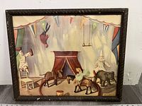 Front view of the framed circus art print showing colorful ring, tent, clowns, and animals.