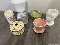 Seven vintage pottery and glass items arranged on floor, showing entire lot contents including planters, candy dish, glass, and decorative containers.