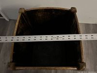 Top-down view of the open planter showing inside diameter with measuring ruler indicating about 23 inches wide.