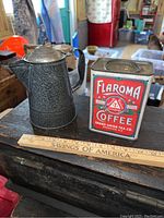 Photo showing the Gray Graniteware Coffee Pot and the Flaroma coffee tin together with a measuring ruler for dimension reference.