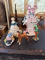 All 5 cast iron items arranged on a dark surface in front of a rustic background, showing group.