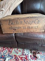 Front view of the wooden shipping box showing the Larkin Soap Co. stencil clearly on the side facing up.