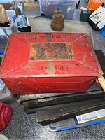 Full top and front view of antique red painted tin egg box showing sliding top lid with stencil text '4 DOZ EGGS' and 'FRAGILE'.