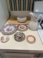 Overview of entire collection showing pitcher, plates, and butter pats on kitchen counter