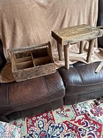 Overall view of the step stool and tool carrier side by side on leather couch with fabric backdrop and patterned rug.