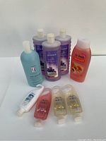 View of all bath and body products in the lot, including Avon Senses bubble bath, Skin So Soft shower gels, St Ives shower gel, and Rusk Sensories detangler