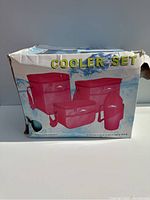 Damaged box showing front with image of red cooler set