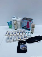 Photo showing full lot with all bottles, boxed device, powders, tubes, and accessories on white background