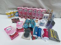 Wide view of all hair removal and personal care products showing multiple Veet wax strip boxes, Dove spray bottles, Gillette razors, Laques sprays, and various creams and cosmetics.
