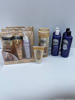 Image showing John Frieda Blonde hair care sachets, mousse, moisturizer tube, hair glaze treatment, and Light Blue Shade shampoo and conditioners in blue bottles.