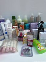 Lot of assorted skincare and hair care products including boxed and bottled items, plus razor blades pack.