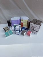 Photo showing all Avon Anew skincare products laid out, including clay masks, creams, serums in various sized boxes.