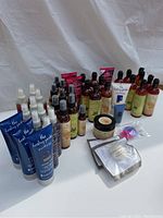 Full lot shot showing grouped bottles and tubes of The Healing Garden body care products including body mists, lotions, scrub jars, and accessories.