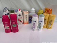 Full view of all 12 assorted body wash bottles on white background