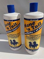 Photo shows two 1-litre plastic bottles, one shampoo and one conditioner from Mane 'n Tail Original series with blue caps and yellow/white labels.