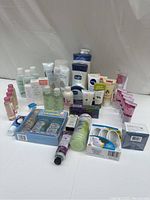 Various miscellaneous cosmetics packed together, mostly bottles and tubes of lotions and creams.