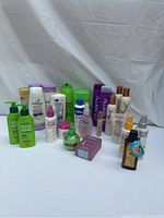 Full lot of mixed hair care products arranged on white backdrop