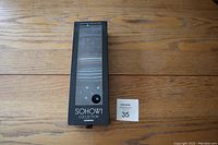 Front view of the black box showing 7 pairs of men's dress socks with assorted patterns through a clear window, labelled SOHOW1 Collection London.