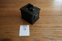 Black rectangular ornamental trinket box showing carved and engraved indigenous design with a killer whale figure on top lid.