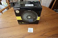 Box front showing Kicker branding, 10 inch subwoofer image, and power rating of 600 watt with yellow accent
