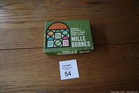 Full view of the green and orange Mille Bornes box with title and branding visible on the lid.