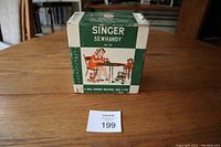 Photo of the original Singer Sew Handy box showing branding and design.