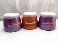 Three sealed large jars of hair mask treatment from the Ice Cream brand. Two purple LISS Perfect Mask jars and one orange Dry-T Mask jar.