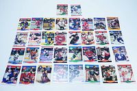 Full lot of 36 hockey cards laid out flat on white background, showing the front of each card with various players and teams.