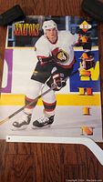 Poster featuring Alexei Yashin skating in Ottawa Senators hockey uniform with bright colorful fonts.