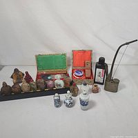 Overview of tray with snuff bottles, porcelain trio in front, calligraphy sets, ink bottle and pipe on white background