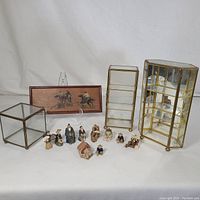 Overview of all display boxes and miniature figurines arranged with box with horse artwork in back and various small figures in front.