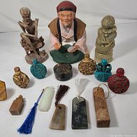 Overall lot view showing all miniature bottles and figurines with varied colors and designs.