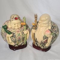 Both large vintage Japanese lucky figures side by side, showing front orientation and details.