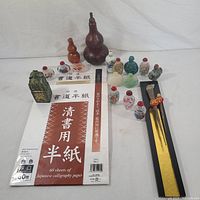 Overview of all snuff bottles, paper pads, seal, gourds and letter openers on white background