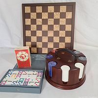 Photo showing the entire game set including chessboard, poker chip holder with chips, dominoes set, and Ichiro cards deck.