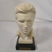 Front view of the off-white Elvis Presley bust showing detailed facial features, hair, collar, and embossed 'ELVIS' on the base.
