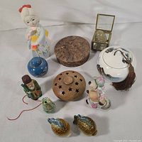 Overview of ceramic and wooden items including figurines, jars, boxes, and salt and pepper shakers