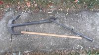 Full anchor laid out next to wooden ruler showing overall length and shape