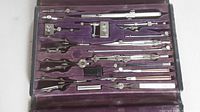 Open case showing all drafting tools arranged in purple velvet slots